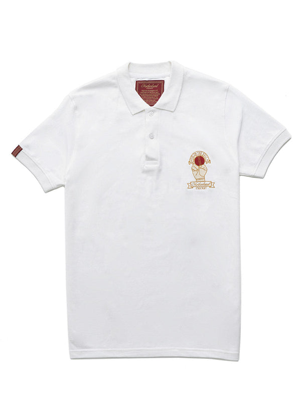 White polo with 'Motherland Cricket' emblem, man holding cricket ball, test cricket inspired.